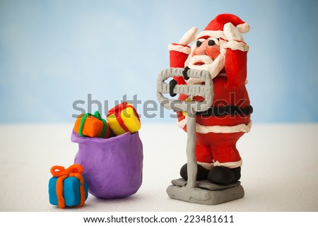 Plasticine Santa Claus on a medical weight scale.