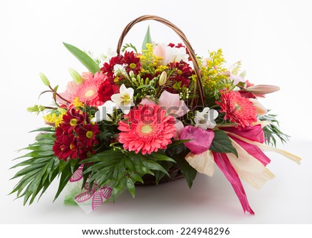 Floral arrangement made of Gerber, Chrysanthemum, Freesia, Goldenrod and Lily flowers  in a basket.