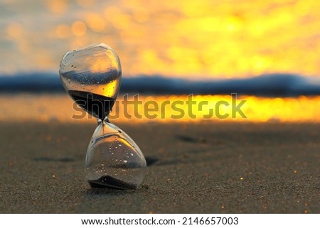 Similar – Image, Stock Photo Further wet beach in the shimmer of the sunset. Waves, clouds and people in the distance.