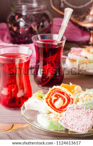 Traditional Turkish Delight on a saucer and hot karkade in cups on a wooden table Stockfoto © 