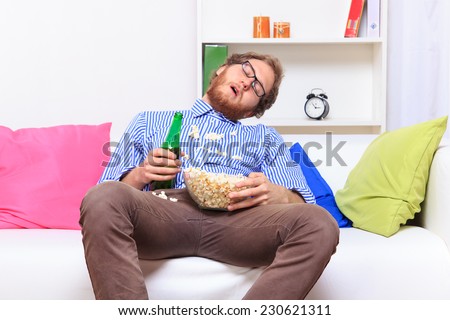 Sleeping at a party with popcorn and beer - studio shoot