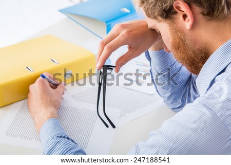 Tired worker rests her head on the desk