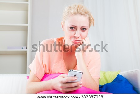 The girl is offended and reads sms at home