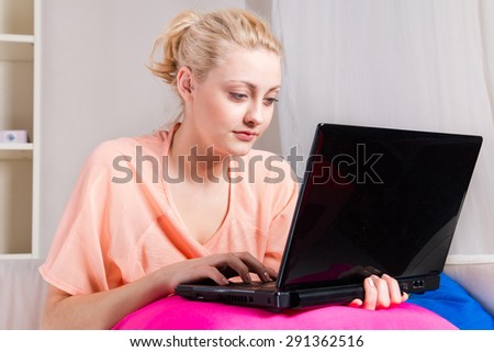 Girl watching the offer on the web at home