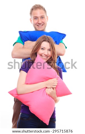 Boy and girl holding colorful pillows