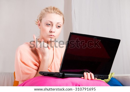 Jealous girl watching laptop at home