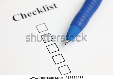 Checklist and ballpoint pen. Closeup.