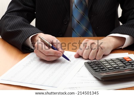 Businessman viewing financial statements. Selective focus. Closeup.