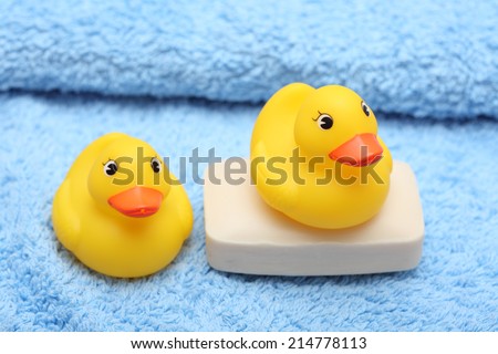 Rubber Ducks on the soft towel and soap. Close-up.