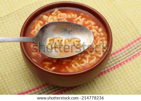 Similar – Image, Stock Photo spoon with letters soup noodles in a white soup plate next to semolina gnocchi and carrot german text hair