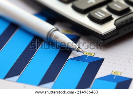 Financial statements. Business Graph. ballpoint pen and calculator on a financial chart or Stock Market Data.
