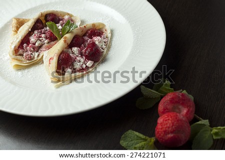 Pancakes stuffed with strawberries and ricotta.