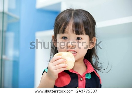 Asian cute girl eating bread