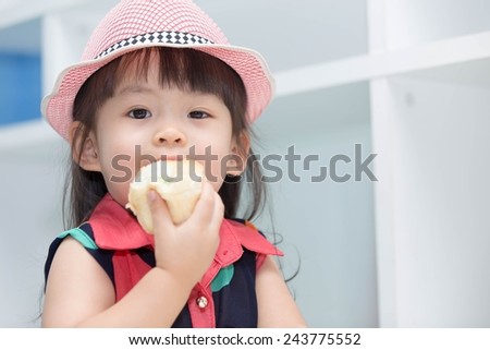Asian cute girl eating bread