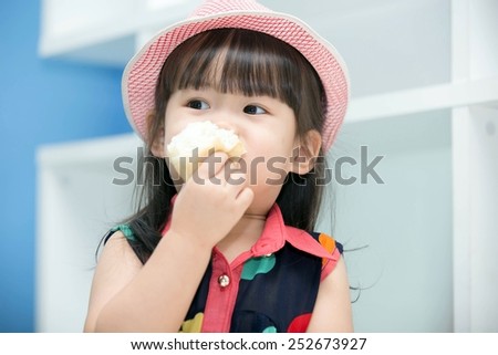 Asian cute girl eating bread.