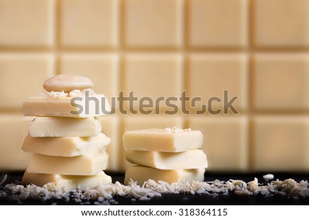 White chocolate with almond. Black base, chocolate in the background.