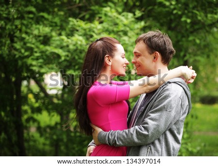 Young beautiful couple in a sweet cheek kiss