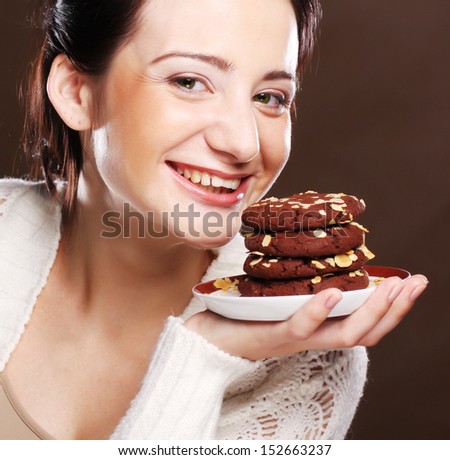 woman eating chocolate chip cookies