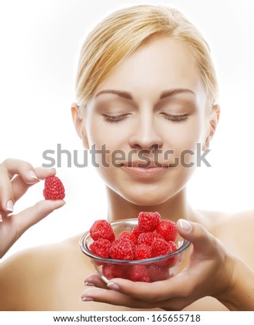 woman eating a raspberry. Isolated over white