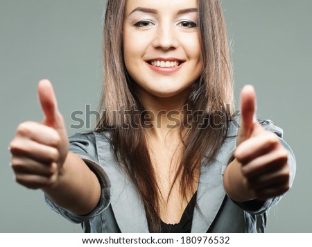 business woman giving thumbs up