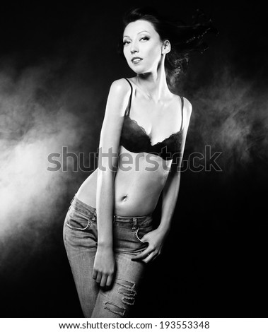 Young sexy brunette woman  striptease dancer, black and white picture