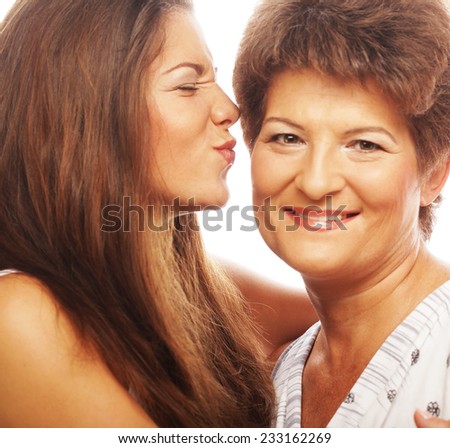 beautiful mature mother and daughter smiling