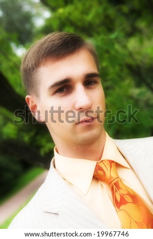 handsome man in business suit during his walk in a park