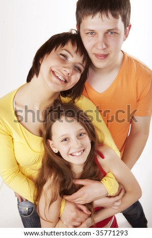 Portrait of joyful family laughing and looking at camera on white background