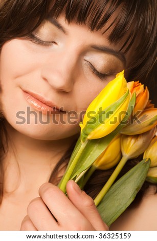 picture of happy woman with yellow tulips  over white