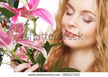 Beauty face of the young woman with pink lily isolated on white