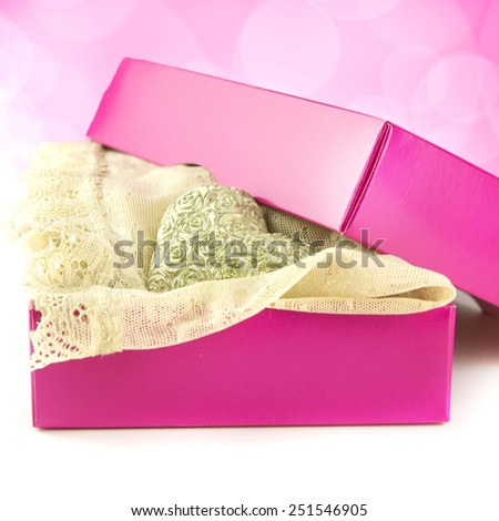 pink present for her with lacy lingerie and rose heart on the soft pink background