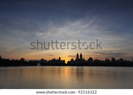 Sunset over buildings of New York City's West Side as seen from the Reservoir in Central Park.