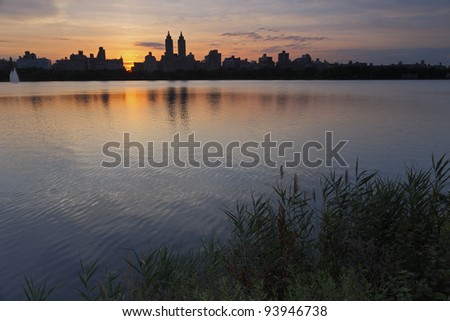 Sunset over buildings of New York City\'s West Side as seen from the Reservoir in Central Park.