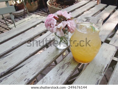 Sweet and sour plum juice with flower pot on the table