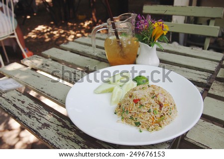 Asian fried rice with cucumber and drinks background