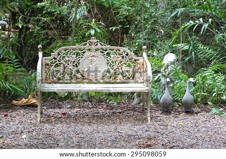 elevation of the exterior vintage seating with ducks sculpture and green leave background
