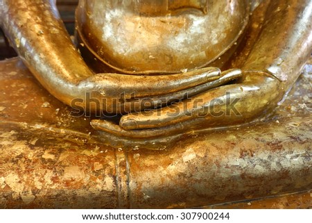 Buddha statue hands  with gold leaves texture
