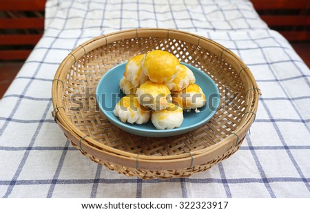 Chinese pastry with salted egg yolk in the blue plate on woven basket