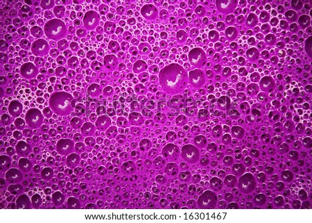 A close-up of purple paint, filled with intricate air bubbles. Perfect for use as a wallpaper or background.