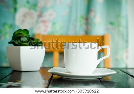 The cup of coffee on the table in the coffee shop