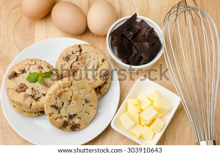 Homemade chocolate cookies and ingredient on wooden background