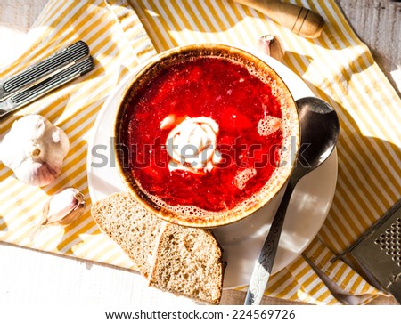 beet soup with beans, garlic sour cream, on a white board