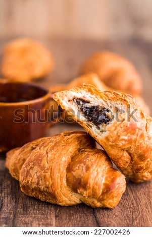 Bite Croissant With Chocolate French Baking On A Wooden Board Bite Croissant With Chocolate French Baking On A Wooden Board