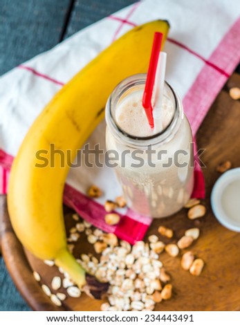 banana smoothie with oat flakes and milk in the bottle, breakfast,top view