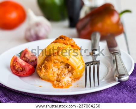 stewed meat stuffed peppers in tomato sauce, dinner, on a white background