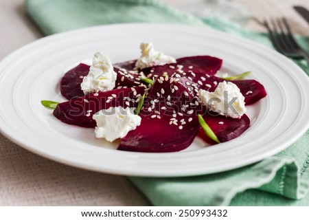roasted beet salad with goat cheese, olive oil and sesame seeds, healthy food