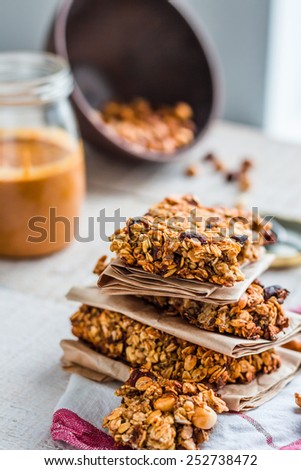 protein bars granola with seeds, peanut butter and dried fruit, healthy snack on wooden background