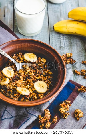 homemade granola with bananas, nuts and dates, milk, healthy food