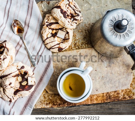 meringue cake with chocolate, caramel and nuts, dessert, rustic, french cuisine