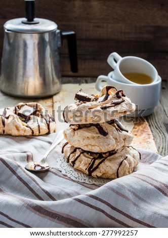 meringue cake with chocolate, caramel and nuts, dessert, rustic, french,selective focus